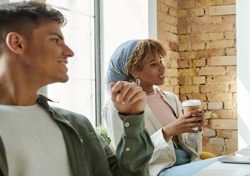 Group of Business owners discussing things over coffee.