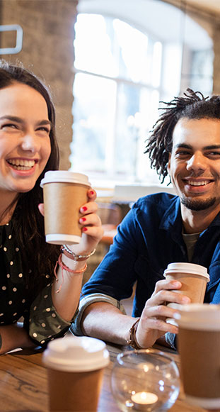 A group of friends enjoying time together while drinking coffee.