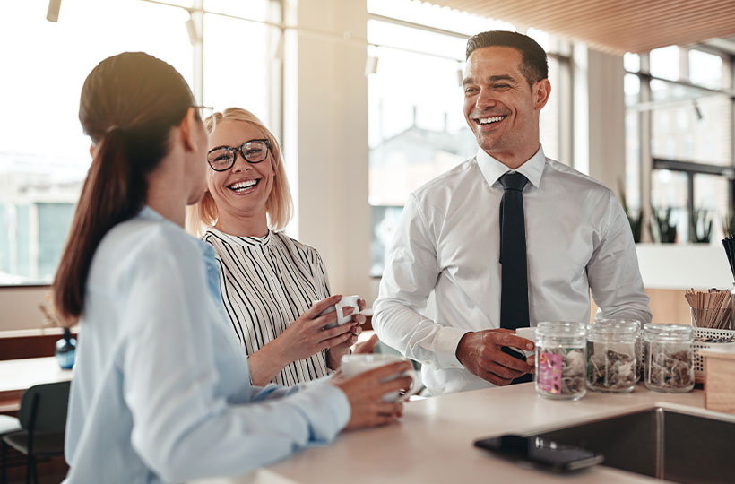 Office workers talking during a coffee break.